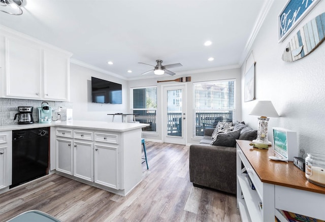 kitchen featuring black dishwasher, light wood-style flooring, ornamental molding, open floor plan, and a peninsula