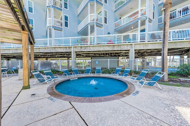 view of pool featuring a patio area and fence