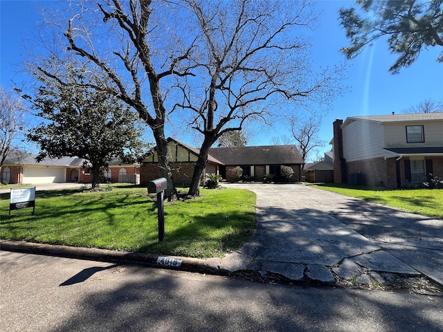 view of front of home featuring driveway and a front lawn