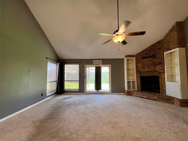 unfurnished living room with high vaulted ceiling, carpet flooring, a ceiling fan, built in features, and a brick fireplace