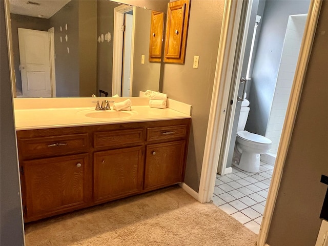 bathroom featuring toilet, tile patterned flooring, and vanity