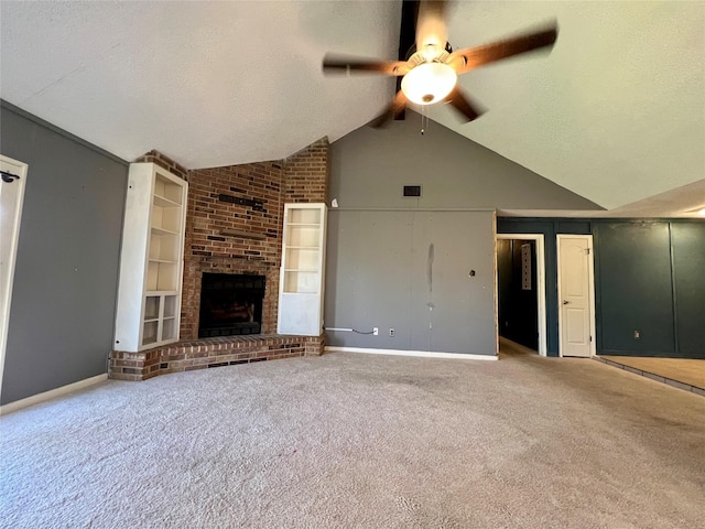 unfurnished living room with a textured ceiling, built in shelves, a fireplace, vaulted ceiling, and carpet