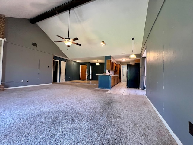 unfurnished living room featuring baseboards, visible vents, ceiling fan, high vaulted ceiling, and beam ceiling