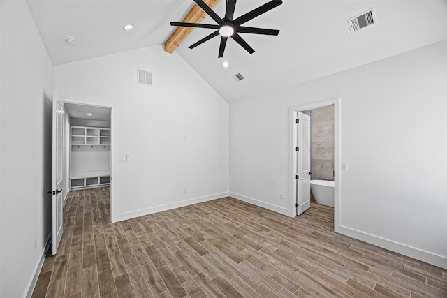 spare room featuring light wood-style floors, visible vents, lofted ceiling with beams, and a ceiling fan