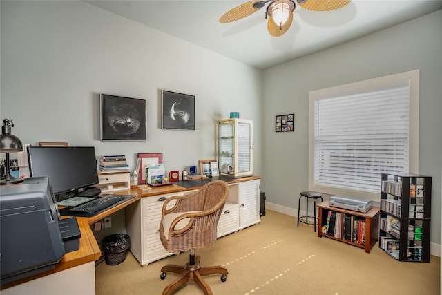 home office with carpet floors, baseboards, and a ceiling fan