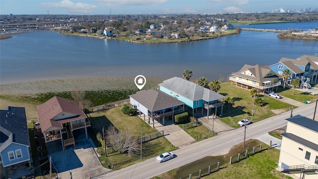 birds eye view of property with a water view and a residential view