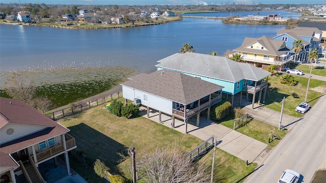 drone / aerial view featuring a water view and a residential view