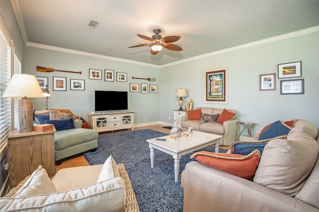 living room featuring crown molding, visible vents, ceiling fan, wood finished floors, and baseboards