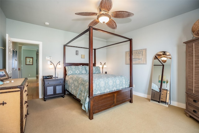 bedroom with light carpet, a ceiling fan, and baseboards