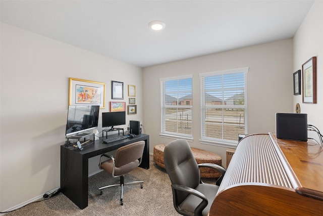 home office with light carpet and baseboards