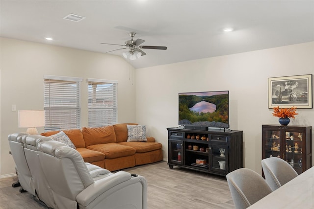 living area with visible vents, ceiling fan, vaulted ceiling, light wood-style floors, and recessed lighting