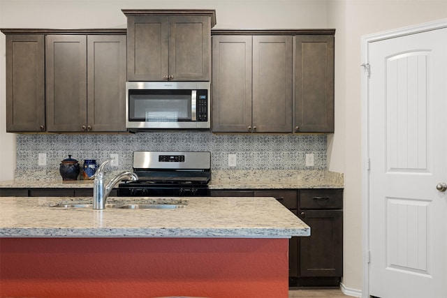 kitchen with appliances with stainless steel finishes and dark brown cabinetry