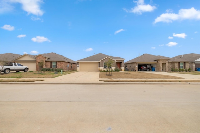 view of front of house with driveway, an attached garage, a residential view, and a front lawn