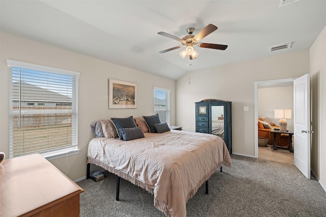 bedroom featuring light colored carpet, visible vents, vaulted ceiling, and baseboards