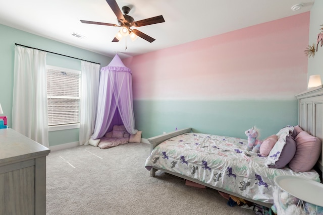 bedroom with baseboards, visible vents, a ceiling fan, and light colored carpet