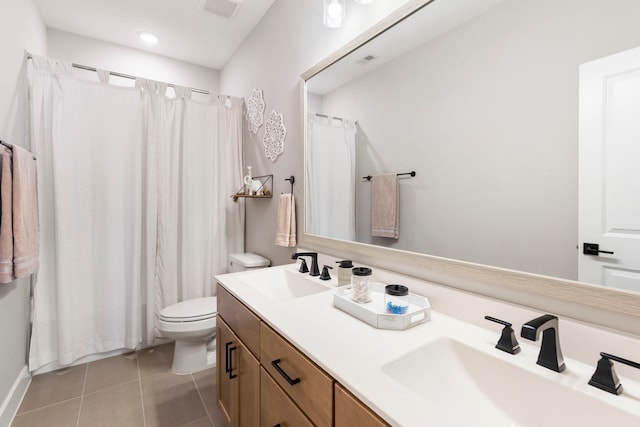 full bath featuring tile patterned flooring, a sink, toilet, and double vanity