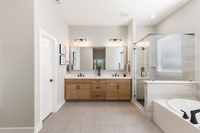 bathroom featuring double vanity, tile patterned flooring, a shower stall, and a sink