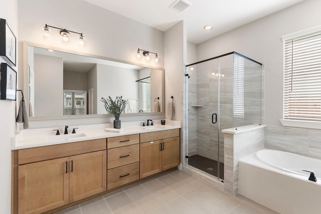 full bathroom featuring a garden tub, tile patterned flooring, a sink, visible vents, and a shower stall