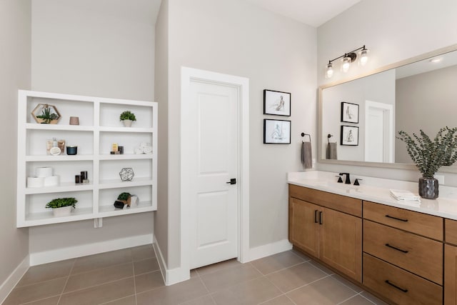 bathroom with tile patterned flooring, vanity, and baseboards