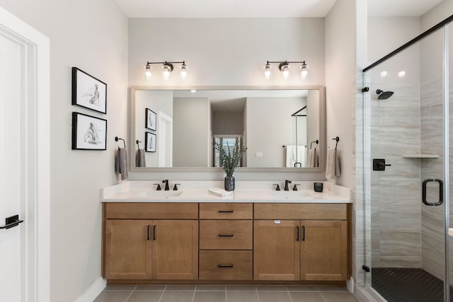 bathroom featuring double vanity, tile patterned floors, a sink, and a shower stall