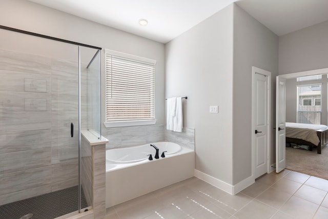 full bath with a garden tub, connected bathroom, a shower stall, tile patterned flooring, and baseboards