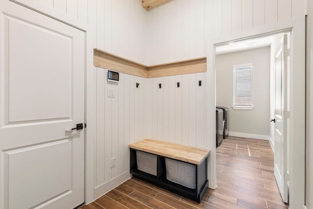 mudroom featuring wood finished floors and baseboards