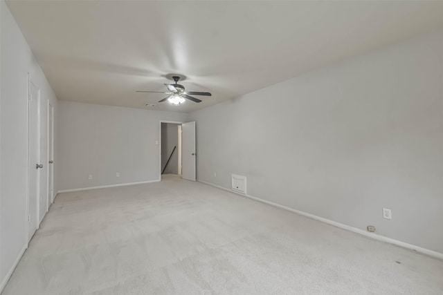 unfurnished bedroom with a ceiling fan, light colored carpet, and baseboards