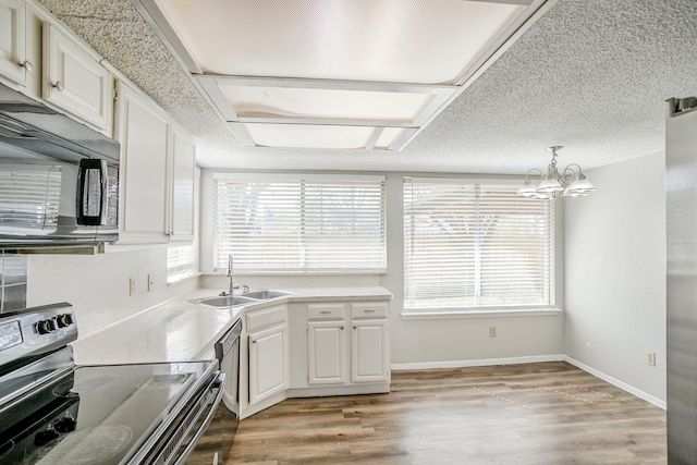 7627 Secretariat Ln, Houston, TX 77071 - kitchen with light countertops, appliances with stainless steel finishes, a sink, and white cabinets