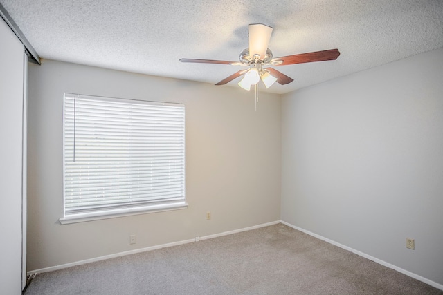 7627 Secretariat Ln, Houston, TX 77071 - spare room featuring light colored carpet, ceiling fan, a textured ceiling, and baseboards