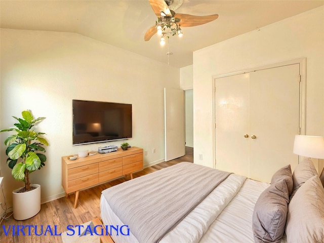 bedroom with wood finished floors, a ceiling fan, baseboards, vaulted ceiling, and a closet