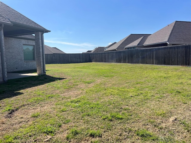 view of yard featuring a patio area and a fenced backyard