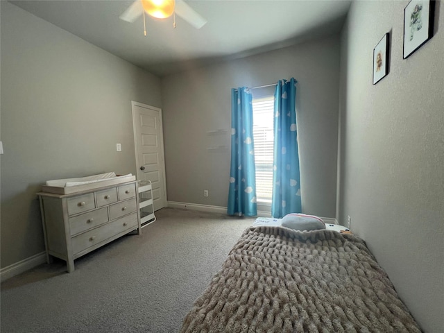 carpeted bedroom with a ceiling fan and baseboards