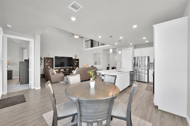 dining space with a ceiling fan, recessed lighting, visible vents, and light wood finished floors