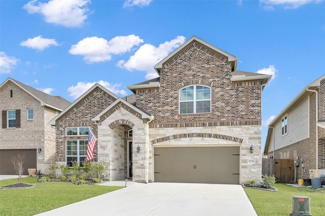 view of front facade with a front yard, stone siding, brick siding, and driveway