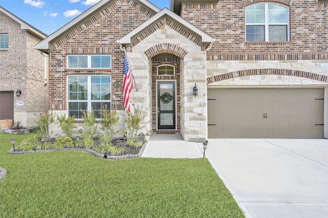 view of front of house with driveway, stone siding, and brick siding