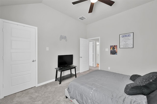 carpeted bedroom with baseboards, visible vents, vaulted ceiling, and a ceiling fan