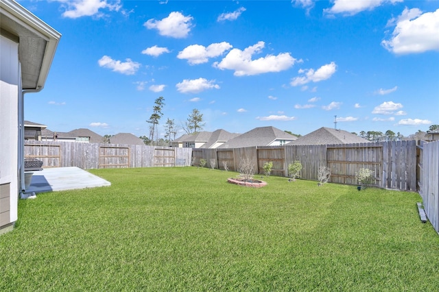 view of yard featuring a patio area and a fenced backyard