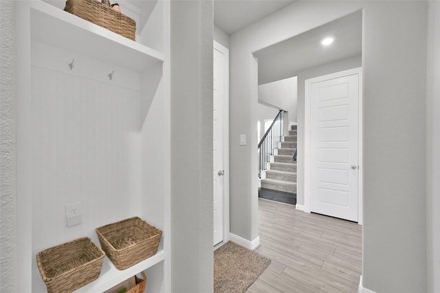 mudroom with light wood-type flooring and baseboards