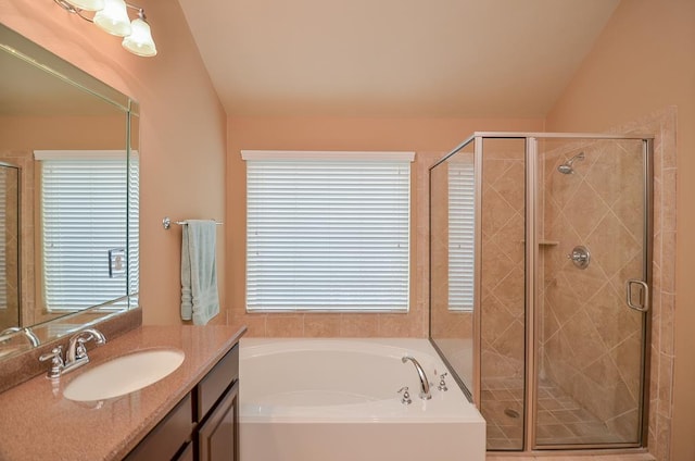 full bathroom featuring a garden tub, vaulted ceiling, a shower stall, and vanity