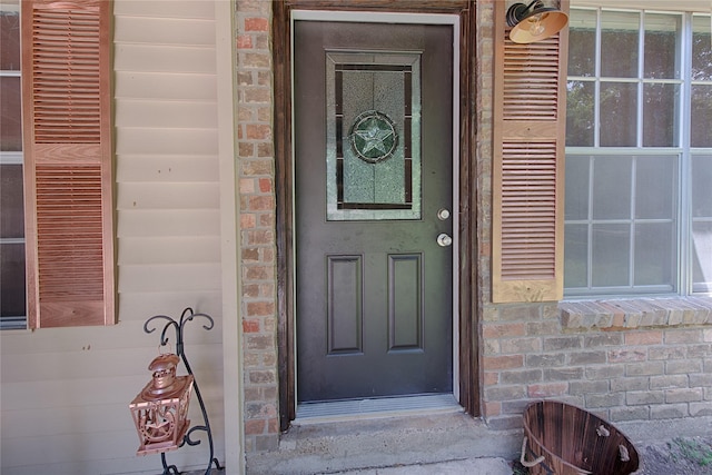 property entrance featuring brick siding