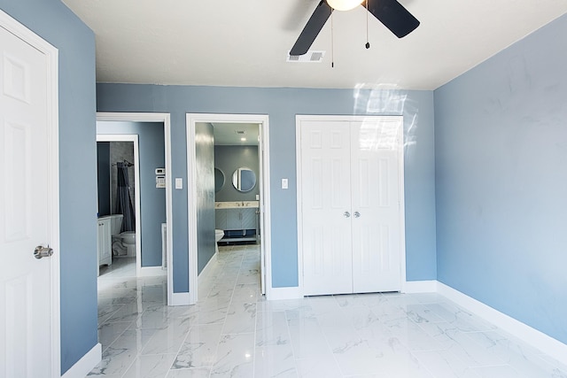 unfurnished bedroom with marble finish floor, a closet, visible vents, and baseboards