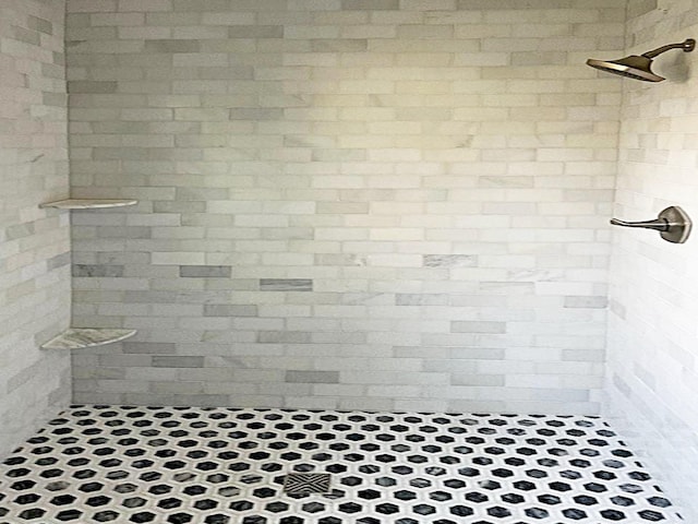 bathroom with a tile shower