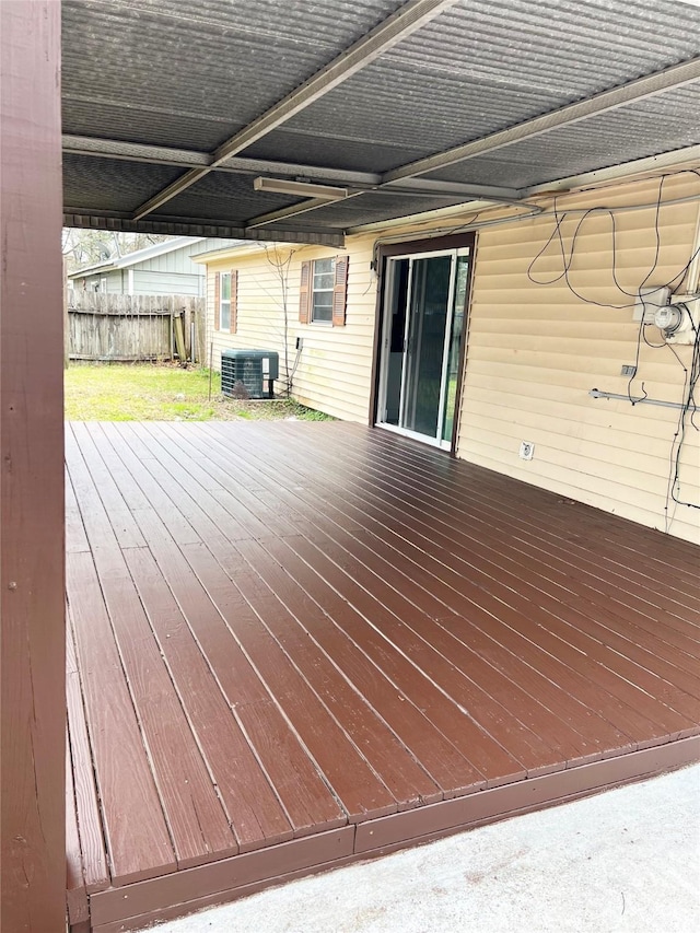 wooden terrace featuring fence and central AC unit