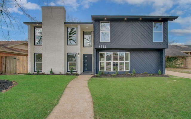 view of front of property with a front yard and a chimney