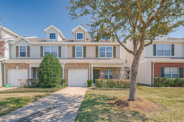 view of front facade featuring a front lawn, concrete driveway, brick siding, and an attached garage