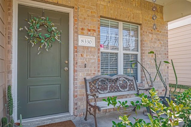 doorway to property with brick siding