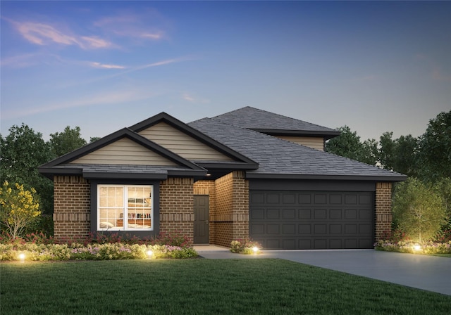 view of front of home with an attached garage, a yard, concrete driveway, and brick siding