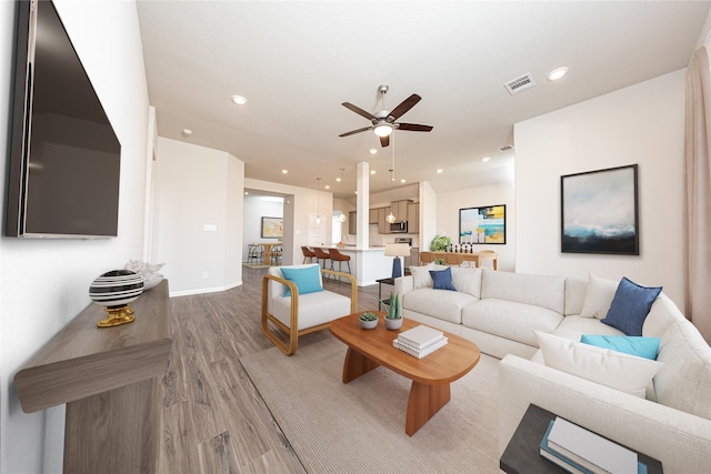 living room featuring a ceiling fan, wood finished floors, visible vents, and recessed lighting