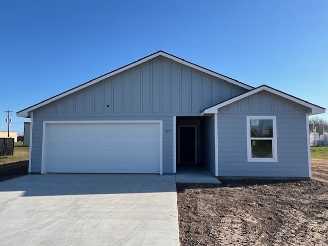 ranch-style house featuring a garage, board and batten siding, and driveway