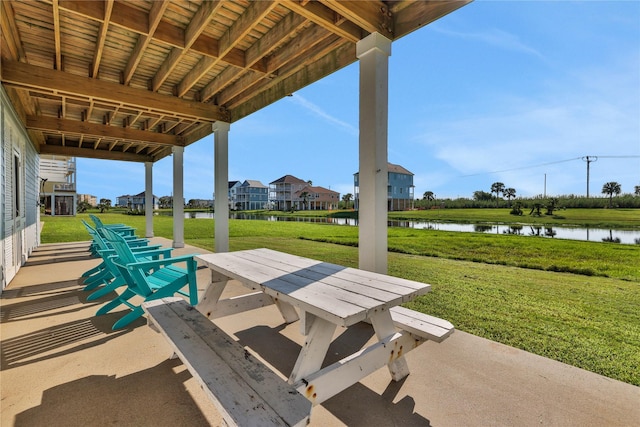 view of patio with outdoor dining space and a water view